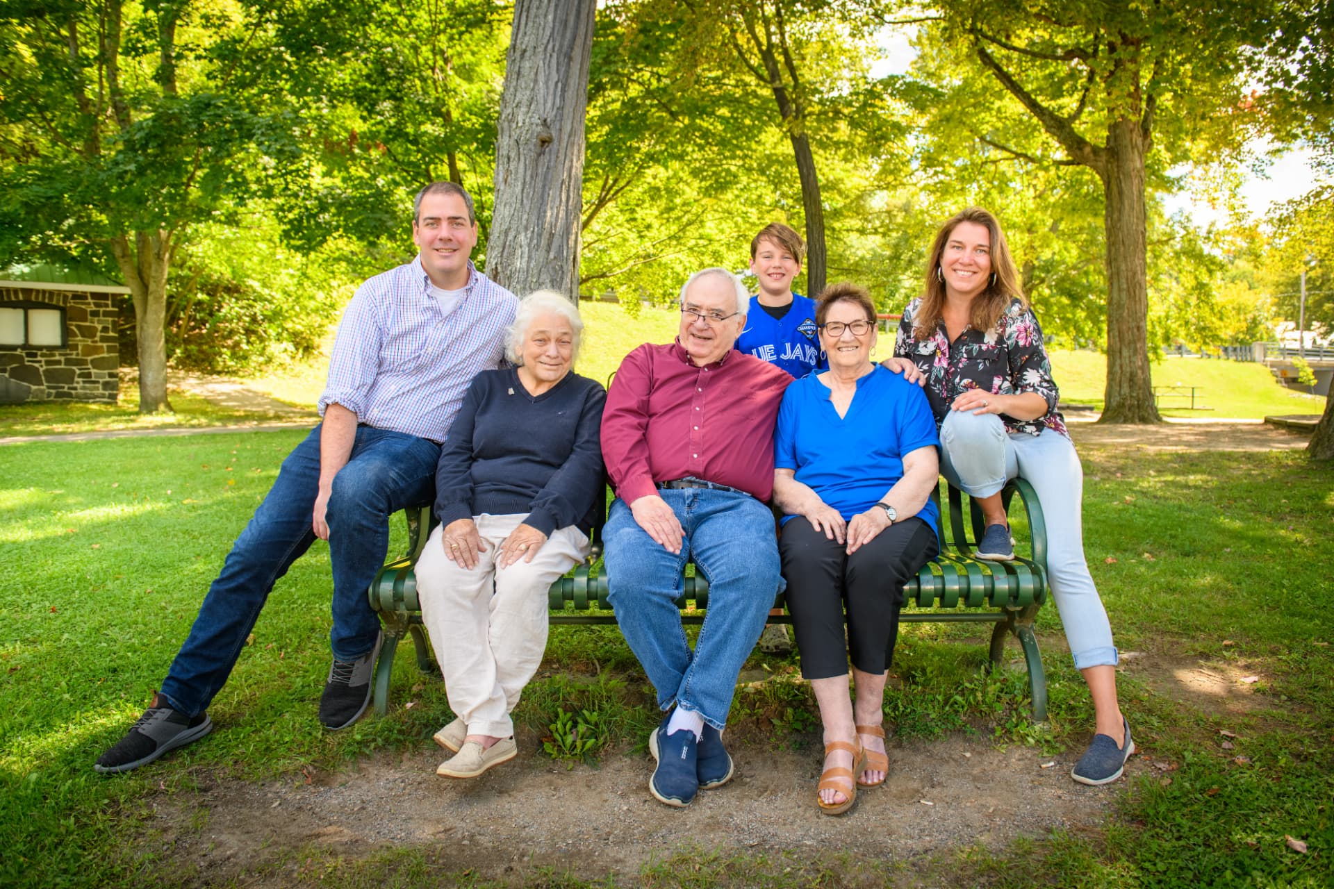 Three generations of Tatiana Sutherland's family together on a park bench in Bracebridge